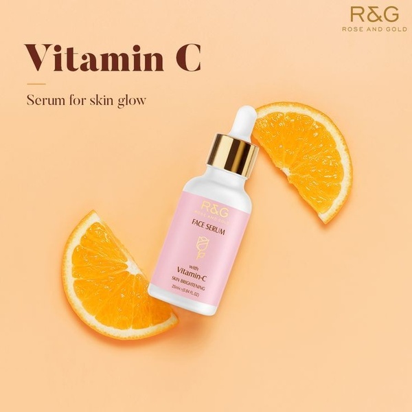 A clean, studio-lit 1:1 image featuring a face serum bottle flanked by fresh orange slices, emphasizing the product's natural brightening ingredients.